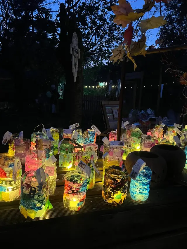 Primo piano delle lanterne decorate dai bambini, accese e piene di colori nel buio